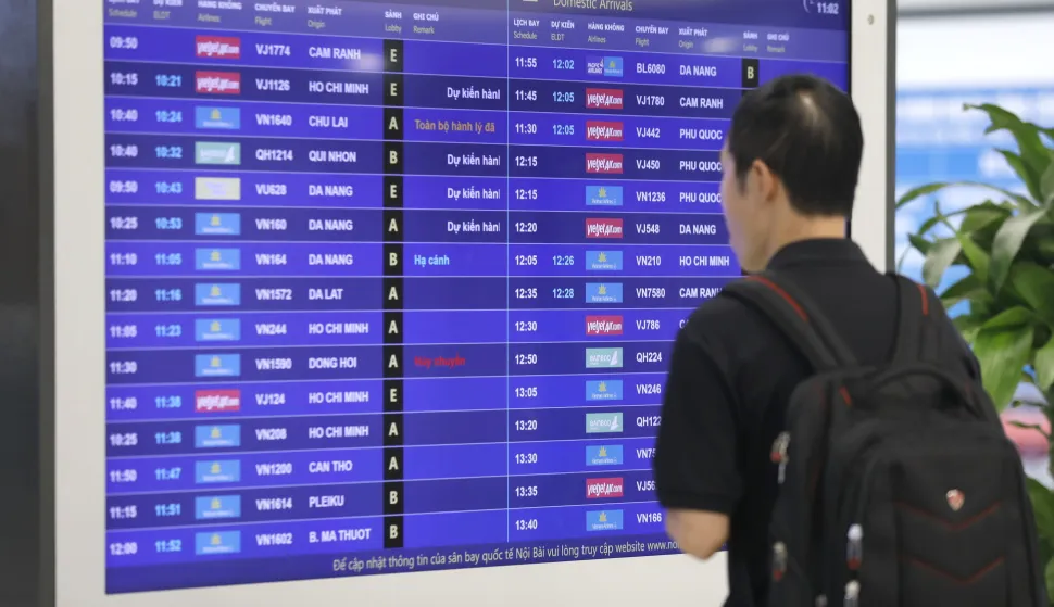 epa12320921 A passenger checks flight information at Not Bai airport in Hanoi, Vietnam, 25 August 2025. Domestic airlines have announced the cancellation and adjustment of many flights as Typhoon Kajiki is forecast to make landfall in Vietnam on 25 August. EPA/LUONG THAI LINH