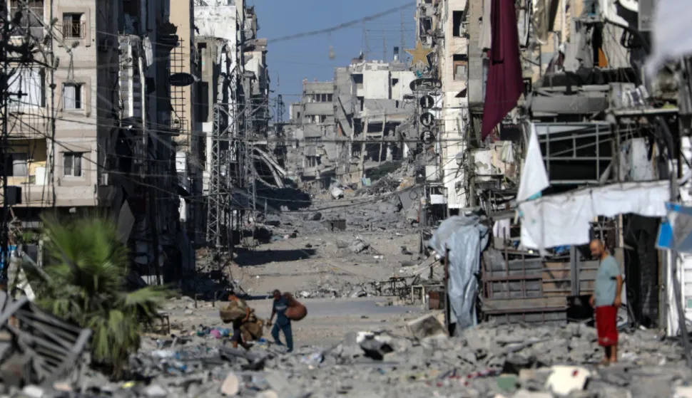 epa12438380 Palestinians move on the damaged Al-Nassr street during an Israeli military operation in Gaza City, Gaza Strip, 07 October 2025. According to the UN around 90 percent of the population or 1.9 million people in Gaza have been displaced since the start of the conflict. More than 67,000 Palestinians have been killed in the Gaza Strip since October 2023, according to the Palestinian Ministry of Health, and about 1,200 Israelis have been killed since the launch of an Israeli military campaign in response to a cross-border attack by Hamas on 07 October 2023. EPA/MOHAMMED SABER