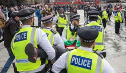epa12429937 Police arrest supporters of the banned Palestine Action group who take part in a civil disobedience protest in Trafalgar Square in London, Britain, 04 October 2025. British police requested that organizers postpone the protest after the Manchester synagogue attack, but the request was refused. Palestine Action was designated a proscribed terrorist organization by the UK government on 05 July 2025. EPA/TAYFUN SALCI