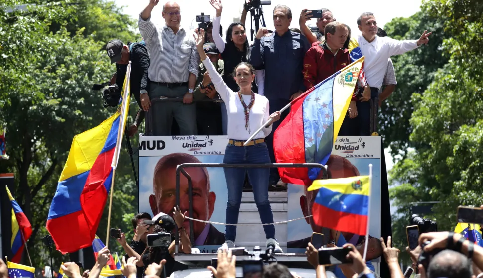 epa11523490 Venezuelan opposition leader Maria Corina Machado (C) attends a protest against the official results of the country's 28 July presidential elections in Caracas, Venezuela, 03 August 2024. The Venezuelan National Electoral Council (CNE) on 02 August 2024 proclaimed Nicolas Maduro as re-elected president of Venezuela. EPA/RONALD PENA R.