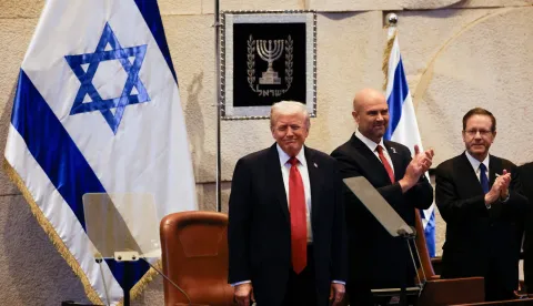 epa12450525 US President Donald Trump (L) reacts next to Amir Ohana (C), Speaker of the Israeli Knesset, and Israeli President Isaac Herzog during an address to the Israeli parliament, the Knesset, in Jerusalem, 13 October 2025. Hamas handed over the 20 surviving Israeli hostages on October 13 under a ceasefire agreement, as the US president and other world leaders geared up for a summit on Gaza. The releases are part of a ceasefire agreement brokered by the US president, with Israel due in return to free nearly 2,000 detainees held in its jails in exchange. EPA/JALAA MAREY/POOL