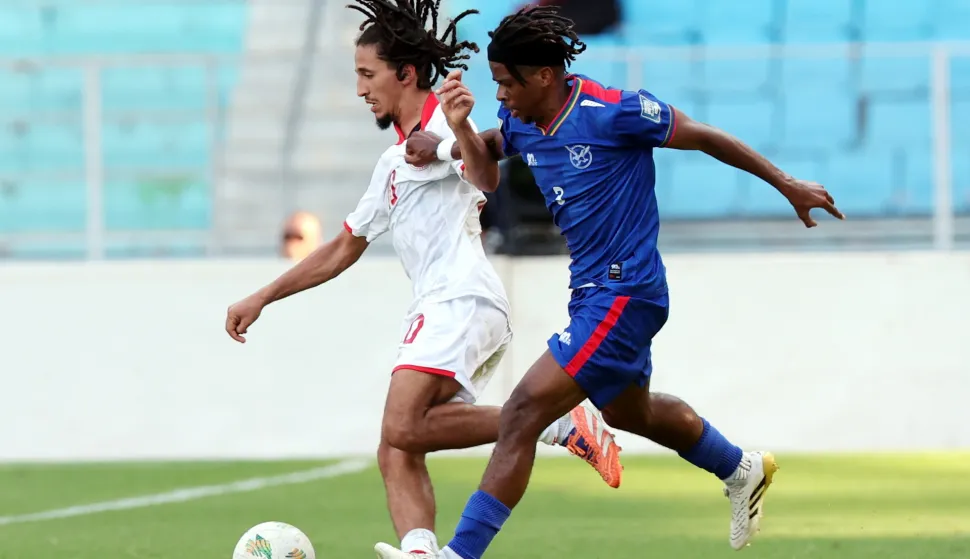 epa12451235 Tunisia's Hannibal Mejbri (L) in action against Namibia's David Ndeunyema (R) during the FIFA World Cup 2026 CAF qualifiers soccer match between Tunisia and Namibia in Tunis, Tunisia, 13 October 2025. EPA/MOHAMED MESSARA