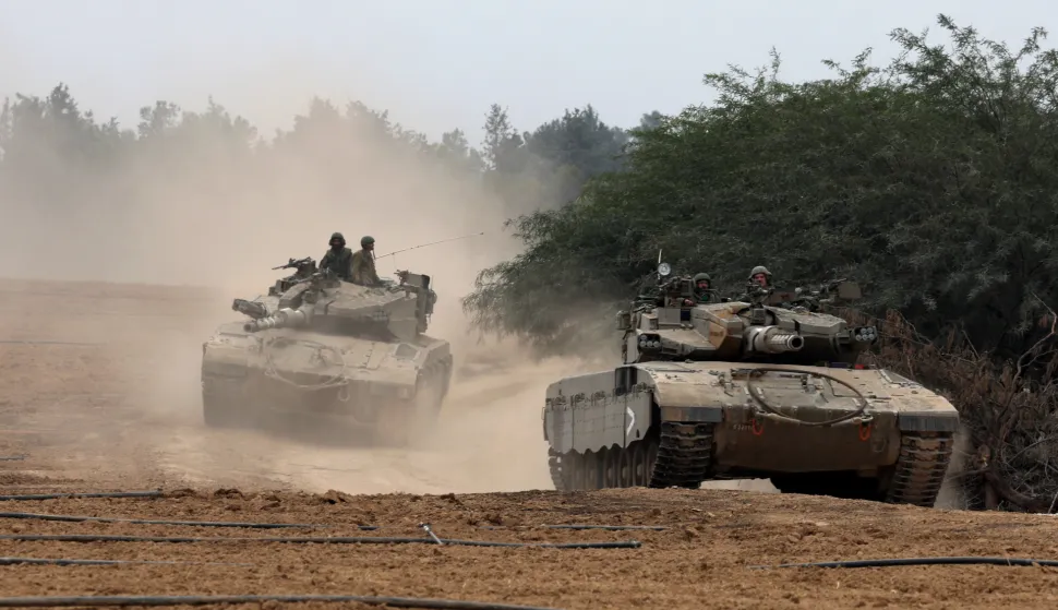 epa11011656 Israeli soldiers aboard armoured fighting vehicles maneuver at an area near the border with the Gaza Strip, in southern Israel, 05 December 2023. Israeli forces resumed military strikes on Gaza after a week-long truce ended on 01 December. More than 15,500 Palestinians and at least 1,200 Israelis have been killed, according to the Palestinian Ministry of Health and the Israel Defense Forces (IDF), since Hamas militants launched an attack against Israel from the Gaza Strip on 07 October, and the Israeli operations in Gaza and the West Bank which followed it. EPA/ATEF SAFADI