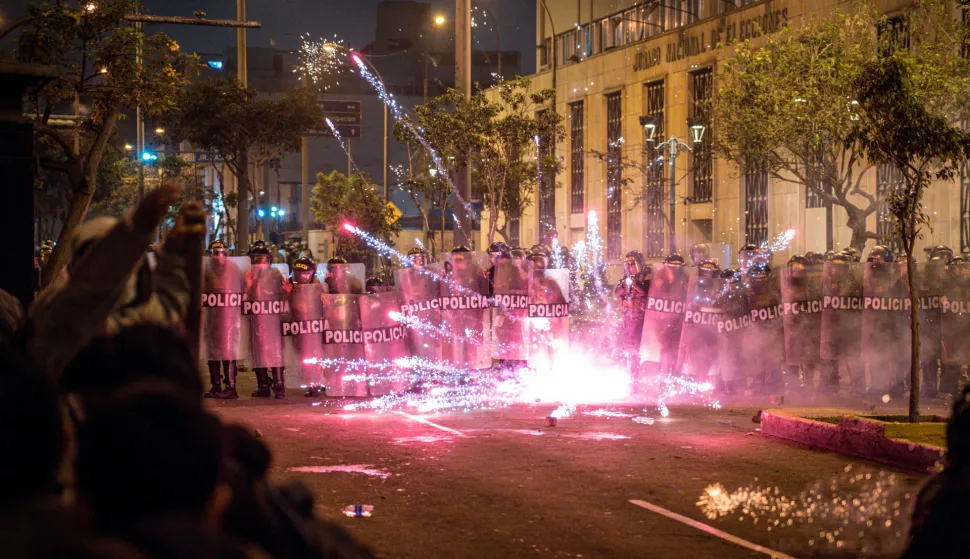 epa12457161 Peruvian police officers stand guard while blocking a flare near Congress during a demonstration against the new government of Jos? Jeri in Lima, Peru, 15 October 2025. People are protesting against rising crime, economic insecurity, and corruption, a day after President Jose Jeri presented his cabinet. EPA/JOHN REYES MEJIA