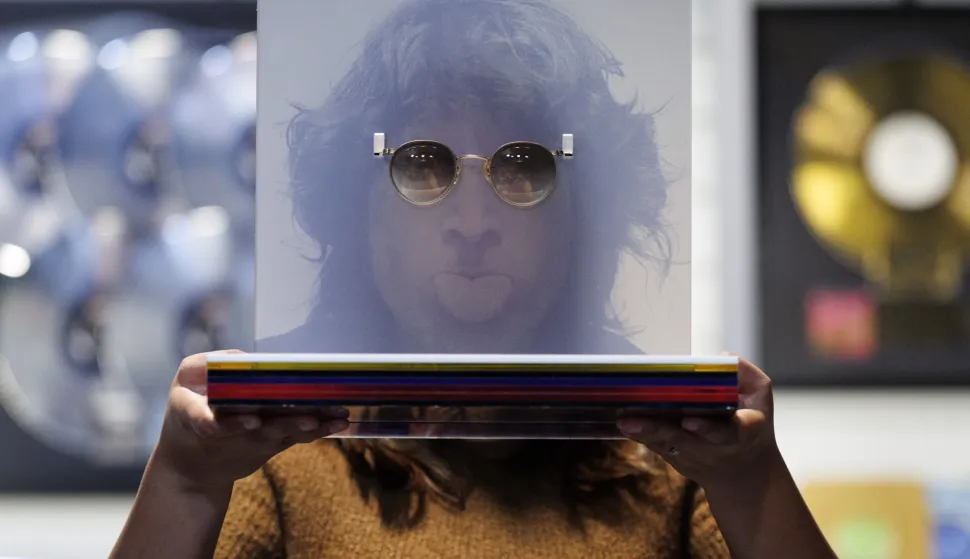 epa12403697 A gallery assistant poses with English musician John Lennon's tinted prescription glasses during a photocall for the upcoming music memorabilia auction by Propstore auction house in Rickmansworth, Hertfordshire, Britain, 24 September 2025 (issued 25 September 2025). The auction of over 550 items from some of the world's most celebrated music artists, with a combined estimated value of 3 million GBP (around 3.4 million Euro), will take place on 23 and 24 October 2025. EPA/TOLGA AKMEN