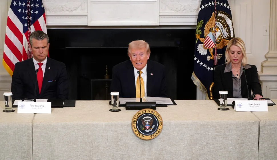 epa12476782 US Secretary of Defense Pete Hegseth (L) and Attorney General Pam Bondi (R) listen to President Donald Trump (C) speak during a roundtable with the Homeland Security Task Force in the State Dining Room of the White House in Washington, DC, USA, 23 October 2025. EPA/WILL OLIVER/POOL POOL