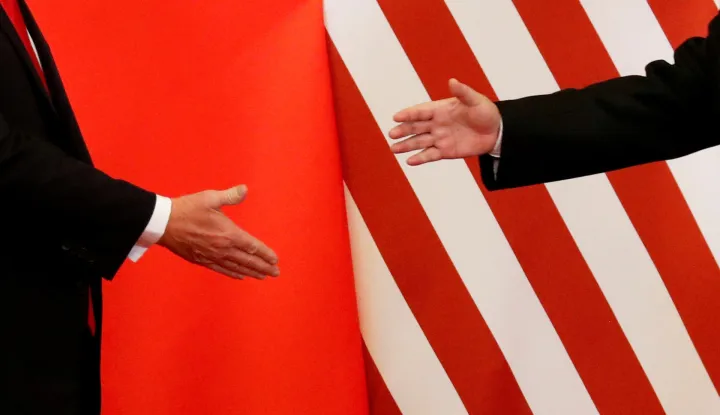 FILE PHOTO: U.S. President Donald Trump and China's President Xi Jinping shake hands after making joint statements at the Great Hall of the People in Beijing, China, November 9, 2017. Damir Sagolj: "It's one of those "how to make a better or at least different shot when two presidents shake hands several times a day, several days in row". If I'm not mistaken in calculation, presidents Xi Jinping of China and Donald Trump of the U.S. shook their hands at least six times in events I covered during Trump's recent visit to China. I would imagine there were some more handshakes I haven't seen but other photographers did. And they all look similar - two big men, smiling and heartily greeting each other until everyone gets their shot. But then there is always something that can make it special - in this case the background made of U.S. and Chinese flags. They shook hands twice in front of it, and the first time it didn't work for me. The second time I positioned myself lower and centrally, and used the longest lens I have to capture only hands reaching for a handshake." REUTERS/Damir Sagolj/File Photo SEARCH "POY TRUMP" FOR THIS STORY. SEARCH "REUTERS POY" FOR ALL BEST OF 2017 PACKAGES. TPX IMAGES OF THE DAY/File Photo Photo: DAMIR SAGOLJ/REUTERS