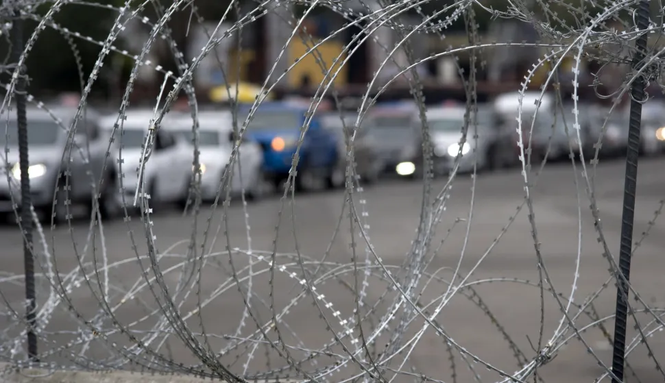 epa07178566 A line of cars waiting to enter the San Ysidro Port of Entry border crossing are pictured through concertina wire, in San Diego, California, USA, 19 November 2018. The US military has been assisting Customs and Border Protection to install concertina wire and other measures to secure the border crossing and the US-Mexico border wall. Asylum seekers frequently cross the US-Mexico border or enter the ports of entry to present themselves to US immigration to seek asylum. EPA/DAVID MAUNG