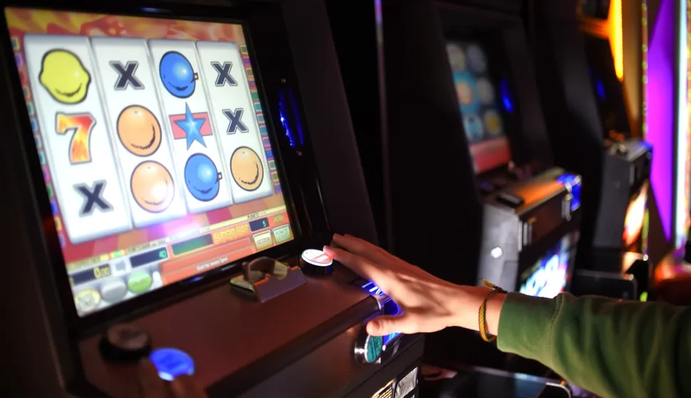ILLUSTRATION - A young man plays around on a slot machine in a casino in Berlin, Germany, 11 March 2015. Photo: Britta Pedersen/dpa