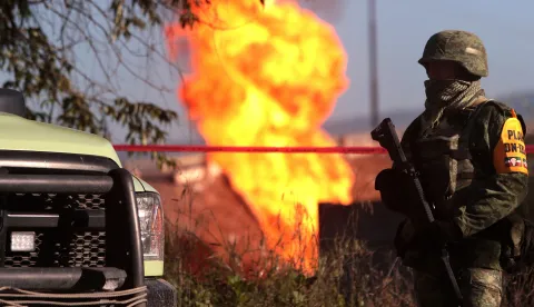 epa06897197 Members of the Mexican Army guard the area near a pipeline fire in the municipality of Acajete, Puebla, Mexico, 18 July 2018. An illegal tapping of a pipeline of Petroleos Mexicanos (Pemex) caused a fire that has not been extinguished in the state of Puebla and no injuries were reported, according to Pemex. EPA/Hilda RA­os