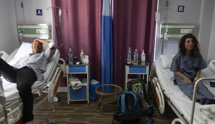 epa12501807 French climbers Didier Berton (L) and Isabelle Thaon (R) receive treatment at the Era Hospital in Kathmandu, Nepal, 04 November 2025, after being rescued by helicopter from Yalung Ri Mountain. At least seven climbers, including two Italians, a Canadian, a German, a French, and two Nepalis, were killed in an avalanche on Yalung Ri Mountain on 03 November 2025. EPA/NARENDRA SHRESTHA