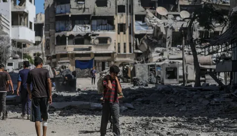 epa12416434 Palestinians walk through a destroyed area following Israeli airstrikes in Gaza City, Gaza Strip, 30 September 2025. More than 66,000 Palestinians have been killed in the Gaza Strip since October 2023, according to the Palestinian Ministry of Health, and about 1,200 Israelis have been killed since the launch of an Israeli military campaign in response to a cross-border attack by Hamas on 07 October 2023. EPA/MOHAMMED SABER