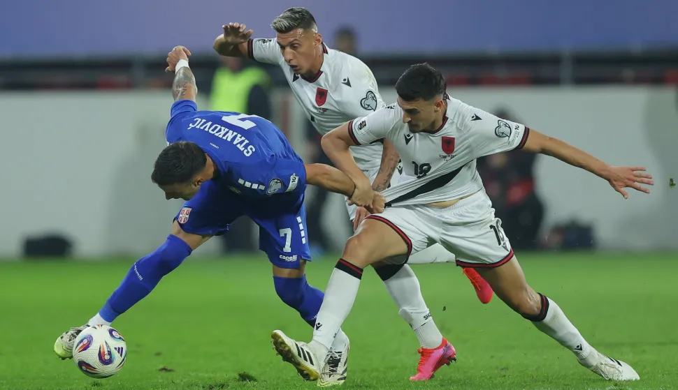 epa12447554 Serbia's Aleksandar Stankovic (L) is tackled by Albania's Juljan Shehu (R) and Albania's Myrto Uzuni (C) during the 2026 FIFA World Cup European Qualifiers Group K soccer match between Serbia and Albania in Leskovac, Serbia, 11 October 2025. EPA/ANDREJ CUKIC