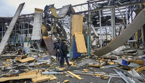 epa12520721 Ukrainian policemen work at the site of a Russian drone strike in Kharkiv, northeastern Ukraine, 12 November 2025, amid the ongoing Russian invasion. At least 3 people were injured after Russian drone strikes on the central area of Kharkiv, according to the head of the Kharkiv Military Administration, Oleg Synegubov EPA/SERGEY KOZLOV