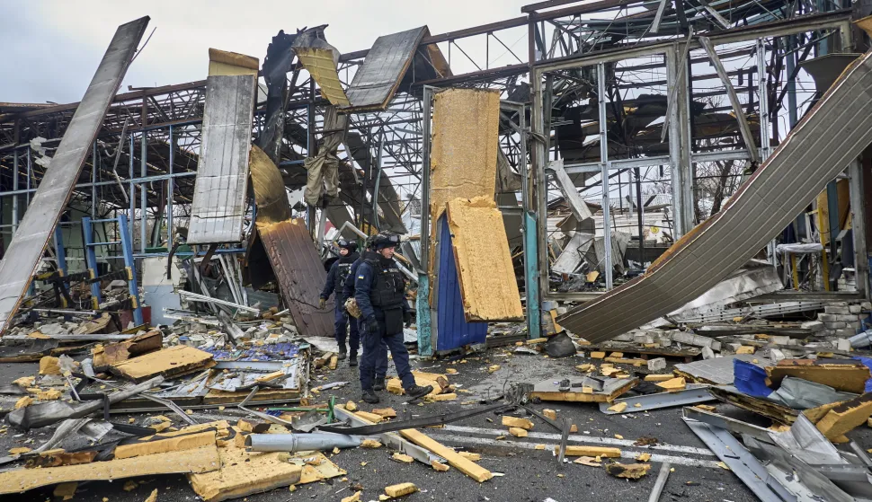 epa12520721 Ukrainian policemen work at the site of a Russian drone strike in Kharkiv, northeastern Ukraine, 12 November 2025, amid the ongoing Russian invasion. At least 3 people were injured after Russian drone strikes on the central area of Kharkiv, according to the head of the Kharkiv Military Administration, Oleg Synegubov EPA/SERGEY KOZLOV