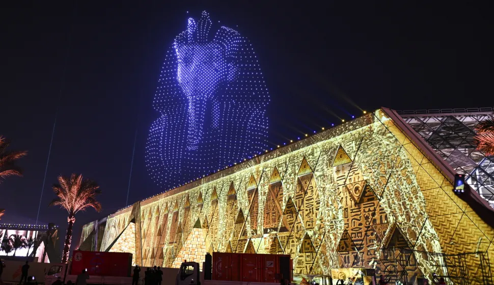 epa12497745 An image created by drones depicting the funerary mask of Tutankhamun lights up the sky above the Grand Egyptian Museum during the opening ceremony in Giza, Egypt, 01 November 2025. The Grand Egyptian Museum, the world's largest museum dedicated to a single civilization, was officially opened on 01 November 2025 with an inauguration ceremony attended by numerous heads of state. EPA/MOHAMED HOSSAM