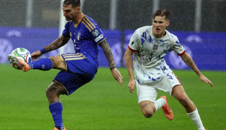 epa12530147 Italy's Matteo Politano (L) challenges for the ball with Norway's David Moller Wolfe during the FIFA World Cup 26 qualifier between Italy and Norway at Giuseppe Meazza stadium in Milan, Italy, 16 November 2025. EPA/MATTEO BAZZI