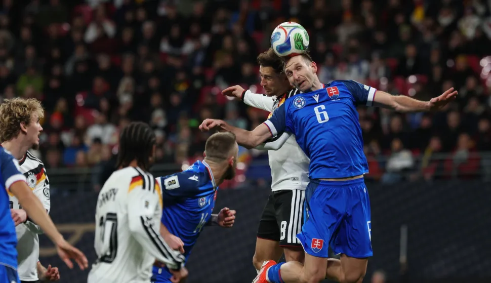 epa12532296 Leon Goretzka of Germany (L) in action against Norbert Gyomber of Slovakia(R) during the FIFA World Cup 26 UEFA qualifier between Germany and Slovakia in Leipzig, Germany, 17 November 2025. EPA/FILIP SINGER