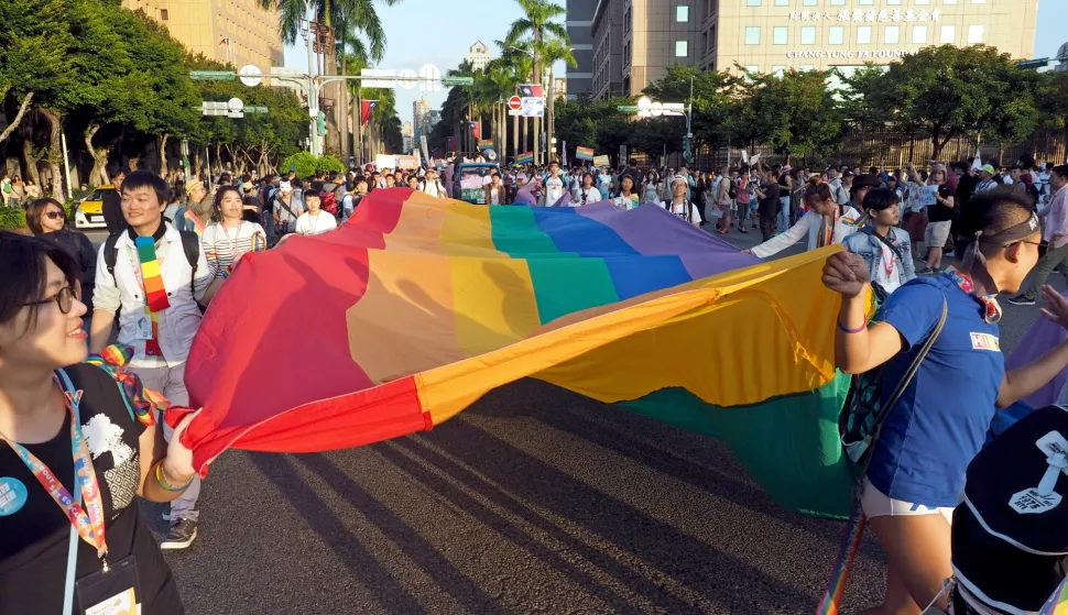 epa07179714 (FILE) - Participants display a large-scale rainbaw flag during the 2018 Taipei Gay Pride March in Taipei, Taiwan, 27 October 2018 (reissued 20 November 2018). On 24 November 2018, Taiwan will hold local elections and ten referendums, including a plebiscite on whether Taiwan should amend civil law, or if it should enact a separate law, to legalize same-sex marriage. In May 2017, Taiwan's Constitutional Court ruled that same-sex couples should be allowed to get married, and gave the legislature two years to amend the law. LGBT groups demand the legislature amend the Civil Code, but conservative forces suggest a separate law to allow same-sex union, which is seen by LGBT (lesbian, gay, bisexual, and transgender) groups as discrimination. EPA/DAVID CHANG