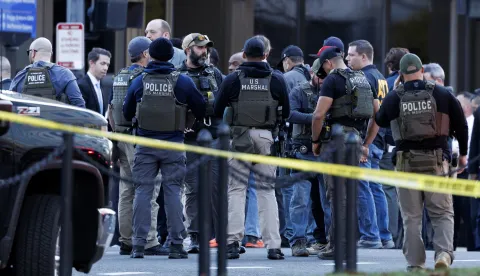 epa12551542 Law enforcement officials stand close to the scene where two West Virginia National Guard members were shot in Washington, DC, USA, 26 November 2025. EPA/WILL OLIVER