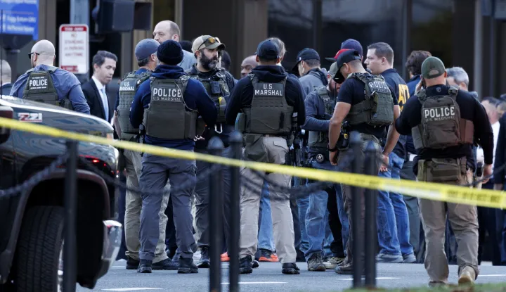 epa12551542 Law enforcement officials stand close to the scene where two West Virginia National Guard members were shot in Washington, DC, USA, 26 November 2025. EPA/WILL OLIVER