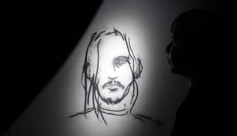 epa12551862 A visitor looks at artworks by Johnny Depp during the press preview of the exhibition 'A Bunch of Stuff' in Tokyo, Japan, 27 November 2025. The exhibition displays paintings, drawings, and other artworks and will be opened to the public from 28 November 2025. EPA/FRANCK ROBICHON