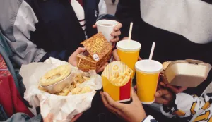 Children holding selection of fast food including fizzy drinks, burger, chips and pie. T0713909R Photo: Press Association/PIXSELL