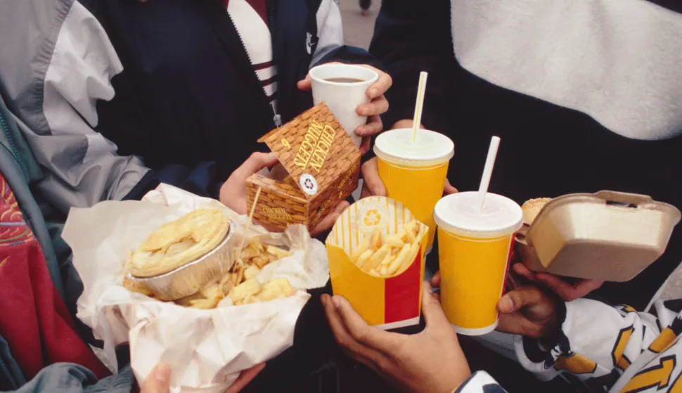 Children holding selection of fast food including fizzy drinks, burger, chips and pie. T0713909R Photo: Press Association/PIXSELL