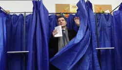 epa12576412 Romanian President Nicusor Dan exits the voting booth after casting his ballot for the capital's mayoral elections at a polling station in Bucharest, Romania, 07 December 2025. The Romanian capital, Bucharest, holds its early mayoral elections on 07 December, following Nicusor Dan's ascent from mayor to President of Romania earlier this year. EPA/ROBERT GHEMENT