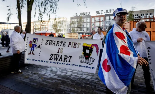 epa07078465 Sympathizers of the traditional figure Black Pete outside the court in Leeuwarden, Netherlands, 08 October 2018. Some 34 people suspected of blocking a road on the day of the national Sinterklaas race in 2017, had to appear in court. Black Pete or Zwarte Piet is the companion of Saint Nicolas during the Sinterklaas (Saint Nicolas) festival celebrated on the evening of 05 December, and has become the subject of much controversy in recent years as some people think it is racist. EPA/ROBIN OF LONKHUIJSEN
