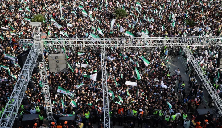 epa12572448 A general view shows hundreds of people gathered in Al-Assi Square during celebrations marking one year since the city's liberation, in Hama, Syria, 05&nbsp;December&nbsp;2025. Syria marks the first anniversary of the sudden collapse of Bashar al-Assad's regime on 08 December 2025, bringing to an end more than five decades of Baathist rule. According to the UN Human Rights Office, the civil war in Syria claimed more than 300.000 civilians' lives from March 2011 to March 2021. Millions of Syrians remain displaced inside the country and as refugees abroad. EPA/BILAL AL-HAMMOUD