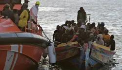 epa12530175 A Spanish Maritime Rescue vessel accompanies a boat carrying migrants to La Restinga Port, in La Restinga, El Hierro, Canary Islands, Spain, 16 November 2025. Sea rescue personnel rescued some 242 migrants traveling in two boats. EPA/GELMERT FINOL