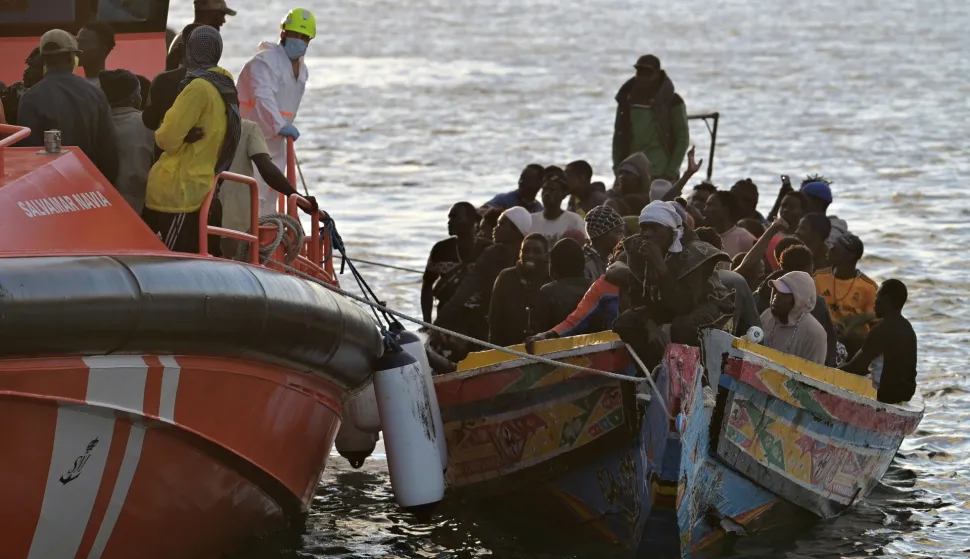 epa12530175 A Spanish Maritime Rescue vessel accompanies a boat carrying migrants to La Restinga Port, in La Restinga, El Hierro, Canary Islands, Spain, 16 November 2025. Sea rescue personnel rescued some 242 migrants traveling in two boats. EPA/GELMERT FINOL