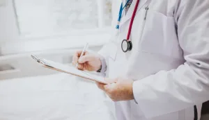 Physician noting down symptoms of a patientdoktor liječnik