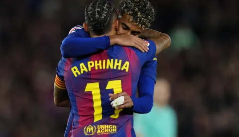 epa12590266 FC Barcelona's Raphinha and Lamine Yamal embrace during the Spanish LaLiga soccer match between FC Barcelona and CA Osasuna, in Barcelona, Spain, 13 December 2025. EPA/Alejandro Garcia