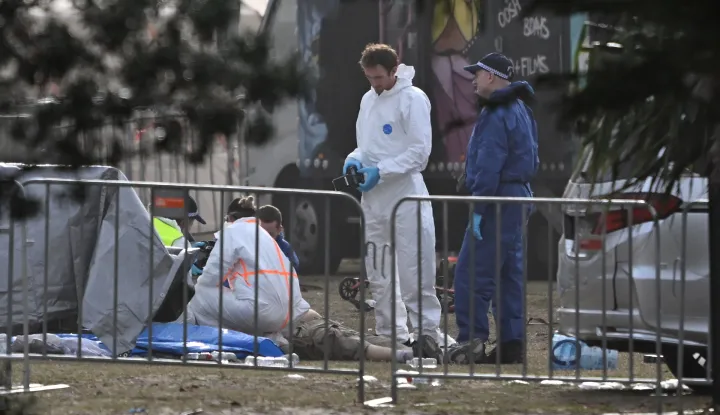 epa12592729 Forensic officers examine a victim's body at the scene of a shooting at Bondi Beach in Sydney, Australia, 15 December 2025. At least 16 people were killed in a shooting incident on 14 December during the Jewish community's Hanukkah festival celebrations at Bondi Beach in Sydney. EPA/DEAN LEWINS AUSTRALIA AND NEW ZEALAND OUT