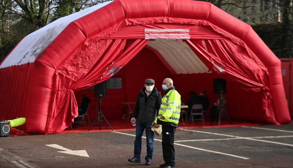 epa08981512 A volunteer centre at Woking Fire Station in Woking, Britain, 02 February 2021. Door-to-door testing of some eighty thousand people is underway in England to find cases of the South Africa coronavirus variant. Eleven cases were discovered in people with no links to travel or previous cases of the strain. British Health Secretary Matt Hancock stated it is 'on all of us' to contain the new variant, which is feared to be spreading in communities. EPA/ANDY RAIN