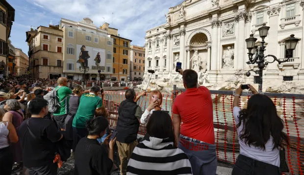 epa11650519 Tourists visit the Fontana di Trevi (Trevi Fountain), as it is cordoned due to the start of maintenance work, in Rome, Italy, 09 October 2024. According to the mayor of Rome, maintenance works, supervised by the Capitoline Superintendency, are expected to last until the end of the year. He also added that Trevi Fountain access would be limited during the Roman Catholic Jubilee Holy Year of 2025 as part of a pilot scheme that may introduce a fee. EPA/FABIO FRUSTACI