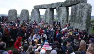 epa12606778 Revellers during the Winter Solstice at Stonehenge near Amesbury, Britain, 21 December 2025. The winter solstice, also known as midwinter, marks the day with the shortest period of daylight and the longest night of the year. Stonehenge, which was constructed in 3000BC is a prehistoric megalithic structure on Salisbury Plain amid a complex of Neolithic and Bronze Age monuments. It is thought to be aligned to the sun's movement during the summer and winter solstice. EPA/NEIL HALL