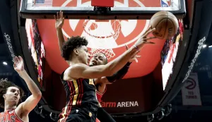 epa12608176 Atlanta Hawks forward Jalen Johnson (L) in action against Chicago Bulls forward Isaac Okoro (R) during the first half of an NBA basketball game between the Chicago Bulls and the Atlanta Hawks in Atlanta, Georgia, USA, 21 December 2025. EPA/ERIK S. LESSER SHUTTERSTOCK OUT