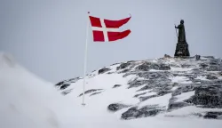 epa11953191 A view of the Dannebrog and Hans Egede Statue in Nuuk, Greenland, 09 March 2025 (issued 10 March 2025). Greenlanders are holding elections for Greenland's parliament, Inatsisartut, on 11 March 2025. EPA/Mads Claus Rasmussen DENMARK OUT