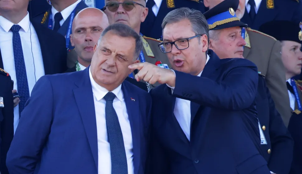 epa12392420 Serbian President Aleksandar Vucic (R) and disputed President of Republika Srpska Milorad Dodik (L) attend the 'Power of Unity' military parade marking Unity, Freedom and National Flag Day in Belgrade, Serbia, 20 September 2025. Around 6,000 troops took part alongside 4,000 in support roles, with new weapons and vehicles displayed. EPA/ANDREJ CUKIC