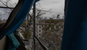 Workers clear debris from the roof of a heavily damaged residential building following a drone strike in Kyiv, on December 23, 2025, amid the Russian invasion of Ukraine. Several Ukrainian regions suffered power cuts in frigid winter weather on December 23, 2025, after Russia launched its latest deadly large-scale attack with drones and missiles, authorities said. (Photo by Roman PILIPEY/AFP)