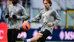 AC Milan's Croatian midfielder #14 Luka Modric warms up ahead of the Italian Serie A football match between AC Milan and Hellas Verona at the San Siro Stadium in Milan, northern Italy, on December 28, 2025. (Photo by Piero CRUCIATTI/AFP)