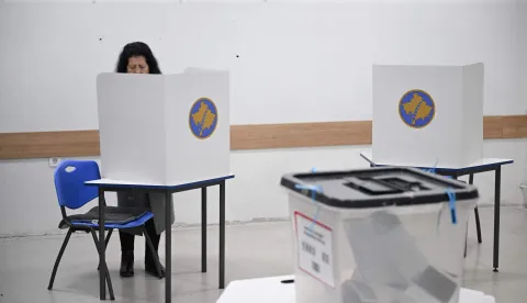 A woman fills her ballot at a polling station in Pristina on December 28, 2025. Kosovo voters head to the polls on December 28, 2025 for snap parliamentary elections, hoping to end ten months of political deadlock and crisis. (Photo by Armend NIMANI/AFP)