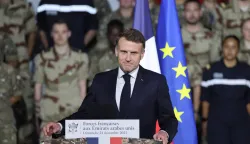 France's President Emmanuel Macron addresses French troops during a ceremony at the 5th Cuirassier Regiment's base in Zayed Military City, near Abu Dhabi, on December 21, 2025. Macron arrived in the United Arab Emirates on December 21 to celebrate Christmas with French troops and to discuss bilateral ties with the Gulf state, as France hopes for more cooperation in its fight against drug trafficking. (Photo by Ludovic MARIN/AFP)