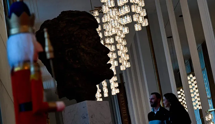 People visit the John F. Kennedy Center for the Performing Arts, which was recently renamed the "Trump Kennedy Center," in Washington, DC, on December 26, 2025. US President Donald Trump's name was affixed to the Kennedy Center in Washington on December 19, 2025, one day after his hand-picked board members voted to rename the arts venue in spite of legal questions. (Photo by Brendan Smialowski/AFP)