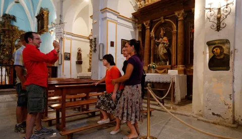 (FILES) People take pictures of the deteriorated version of "Ecce Homo" by 19th-century painter Elias Garcia Martinez, after its restoration by Cecilia Gimenez, 81, at the Borja Church in Zaragoza on August 28, 2012. The Spanish woman whose failed restoration of a century-old painting of Jesus Christ captured global headlines more than a decade ago has died at 94. Cecilia Gimenez rose to international fame in 2012 after her botched restoration of the Ecce Homo fresco at a church in Borja, northeastern Spain, drew worldwide media attention. (Photo by CESAR MANSO/AFP)