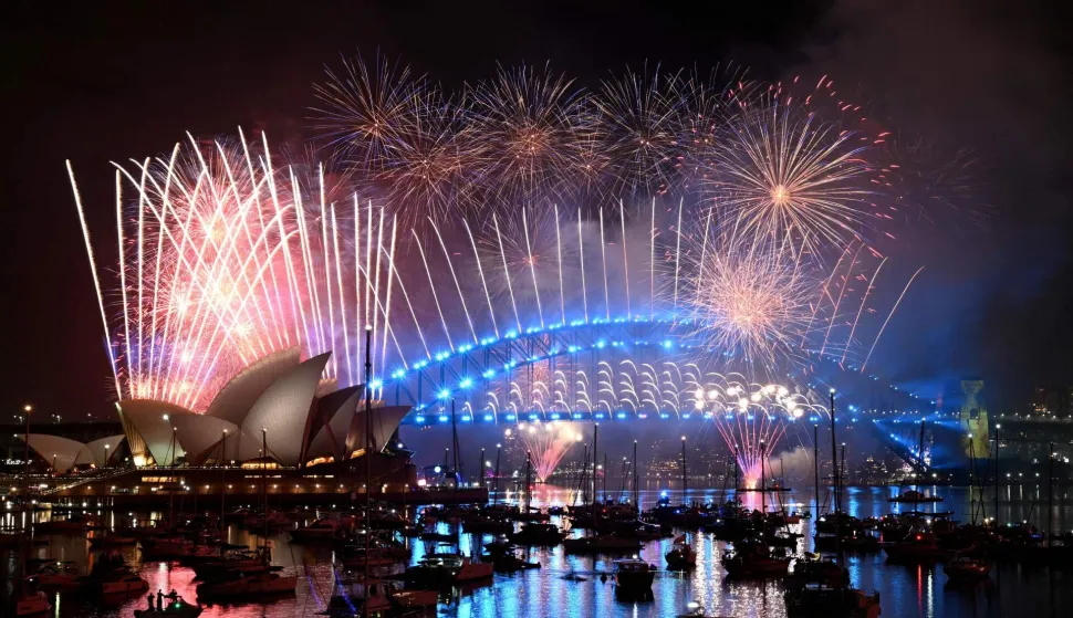 Fireworks light up the midnight sky over Sydney Harbour Bridge and Sydney Opera House during New Year?s Day celebrations in Sydney on January 1, 2026. (Photo by Saeed KHAN/AFP)