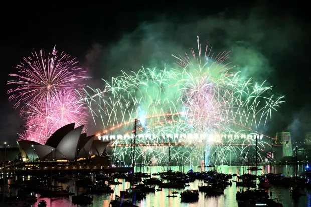 Fireworks light up the midnight sky over Sydney Harbour Bridge and Sydney Opera House during New Year?s Day celebrations in Sydney on January 1, 2026. (Photo by Saeed KHAN/AFP)